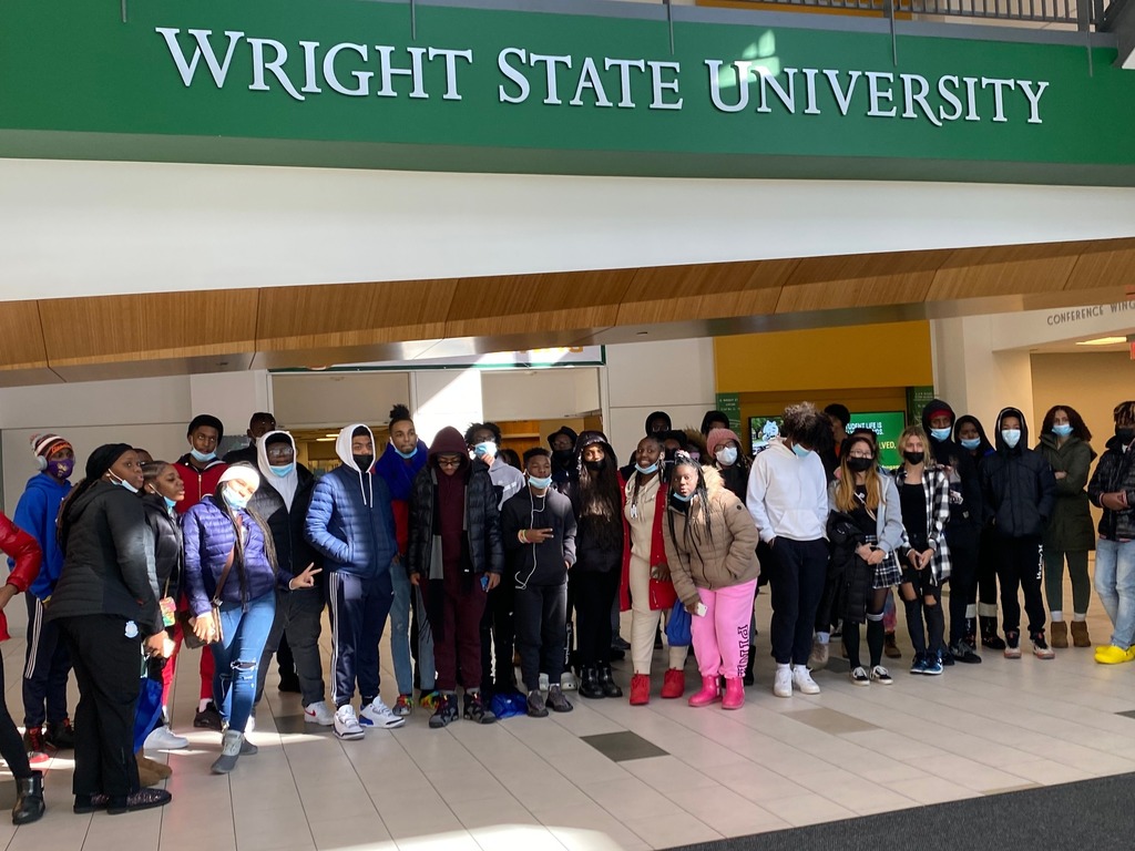 Students in front of a Wright State University sign